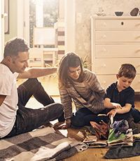 Family reading popup book with son